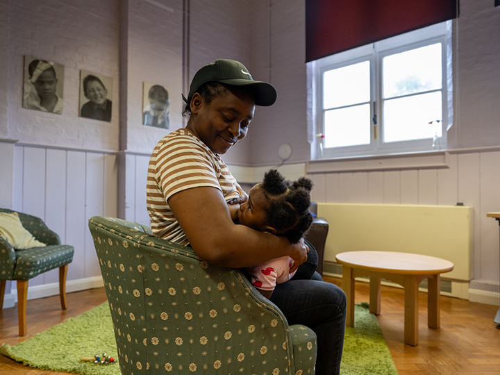 Woman Sitting In A Chair And Breastfeeding Their Child