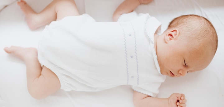 Baby lying on back in crib