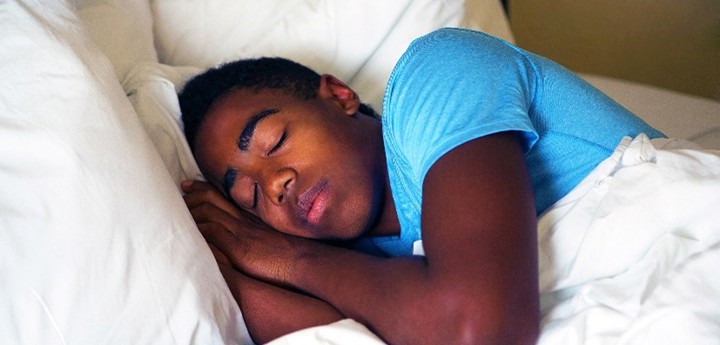 Sleeping teenage boy in bed