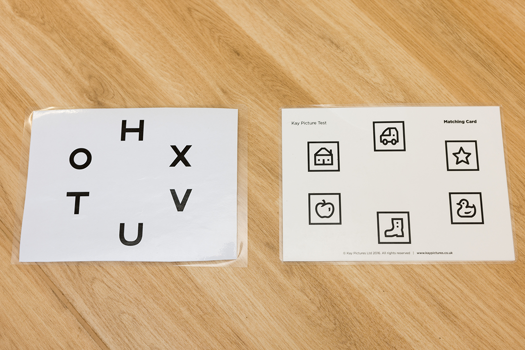 Vision screening picture matching game. Left sheet has letters in a circle. H, X, V, U, T, O. The right sheet has pictures in a circle. Car, star, duck, shoe, apple, house.