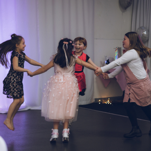 4 girls dancing together and holding hands in a circle