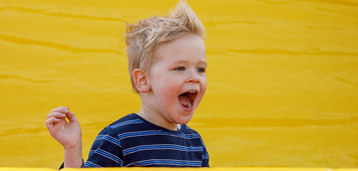 Little boy having fun in inflatable playground