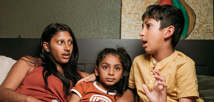 adult and two children talking