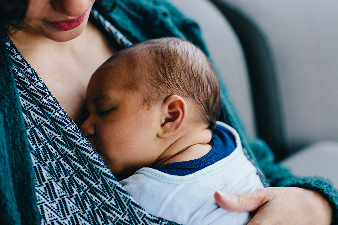 Newborn baby sleeping on mother's chest 