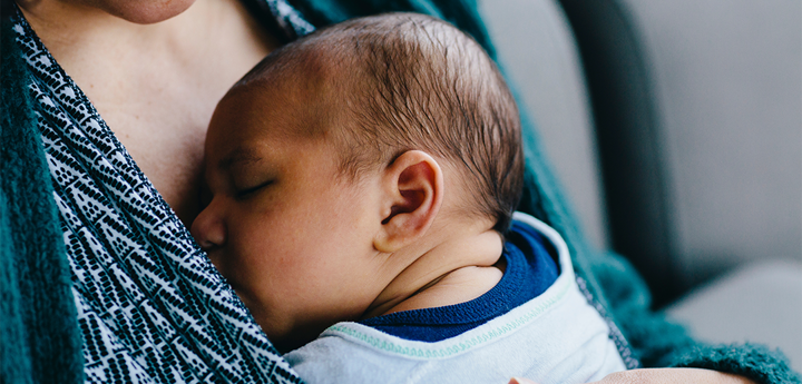 Newborn baby sleeping on mother's chest 