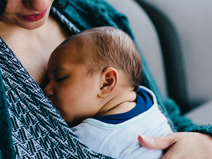 Newborn baby sleeping on mother's chest 